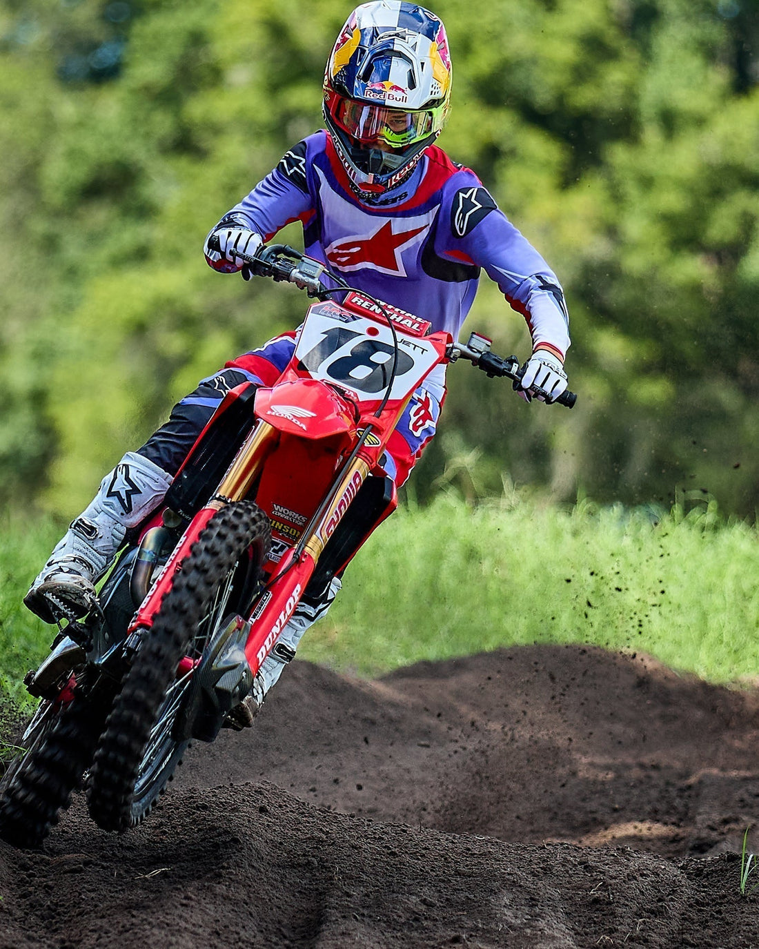 Red motocross bike wearing Alpinestar branded clothing